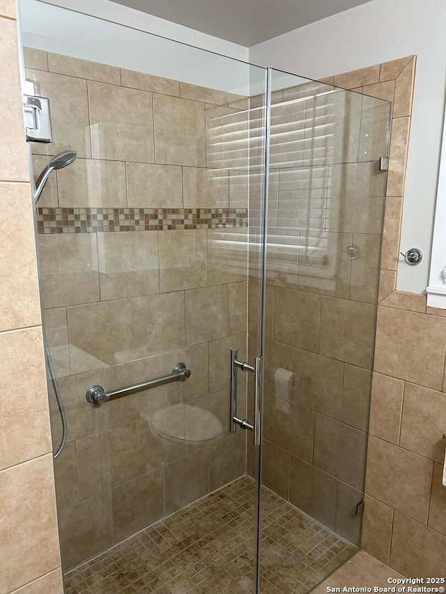 bathroom with toilet and walk in shower