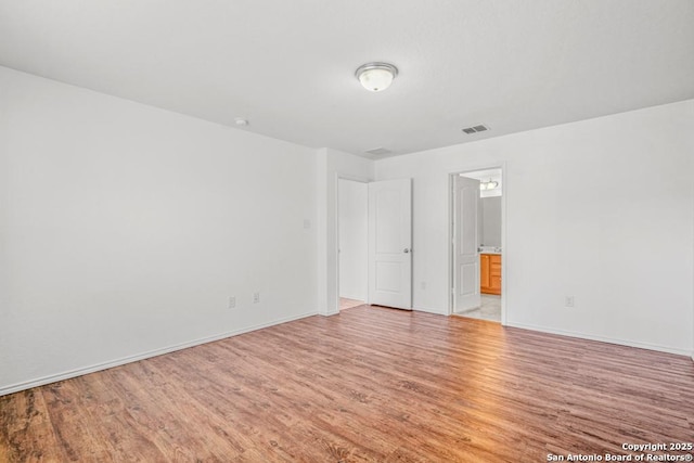 spare room featuring light hardwood / wood-style flooring