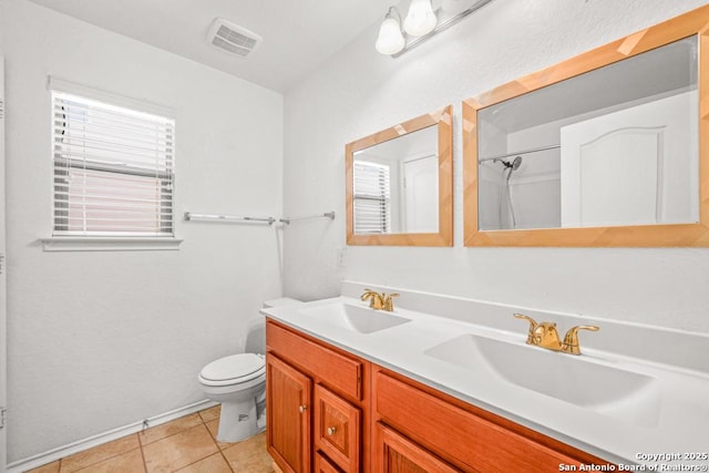 bathroom with vanity, tile patterned floors, and toilet