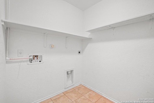 laundry area with gas dryer hookup, light tile patterned floors, hookup for a washing machine, and electric dryer hookup