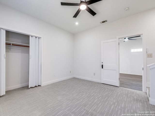 unfurnished bedroom with light carpet, a closet, and ceiling fan