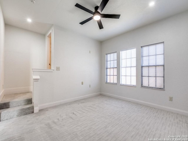 empty room with light carpet and ceiling fan