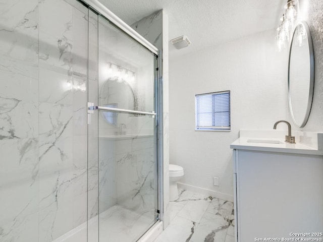 bathroom featuring an enclosed shower, vanity, a textured ceiling, and toilet