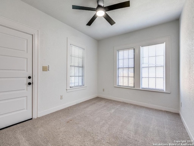 empty room featuring light carpet and ceiling fan