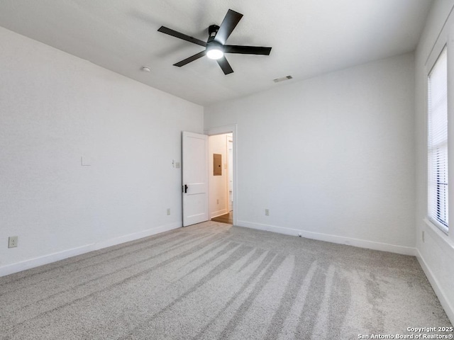 carpeted spare room with electric panel and ceiling fan