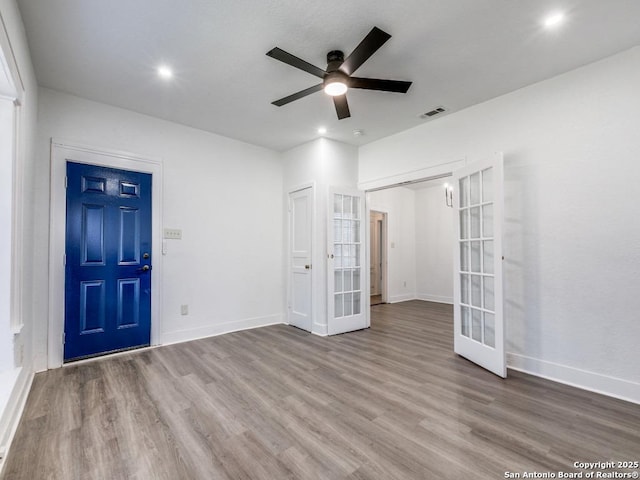 interior space featuring french doors, ceiling fan, and wood-type flooring