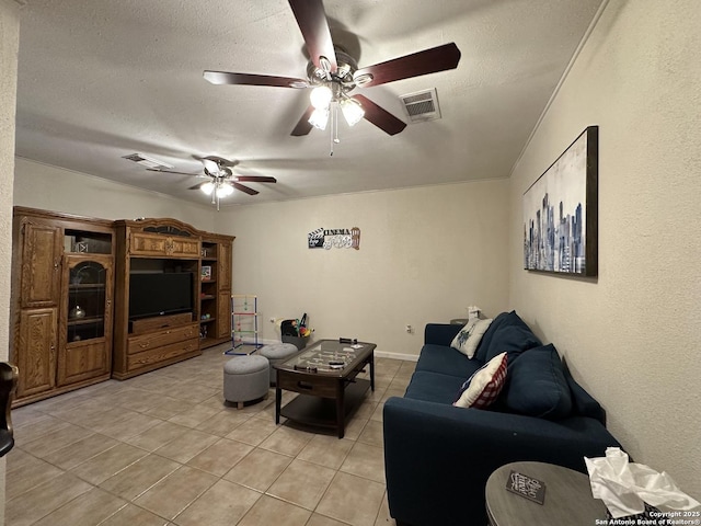 tiled living room featuring ceiling fan and a textured ceiling