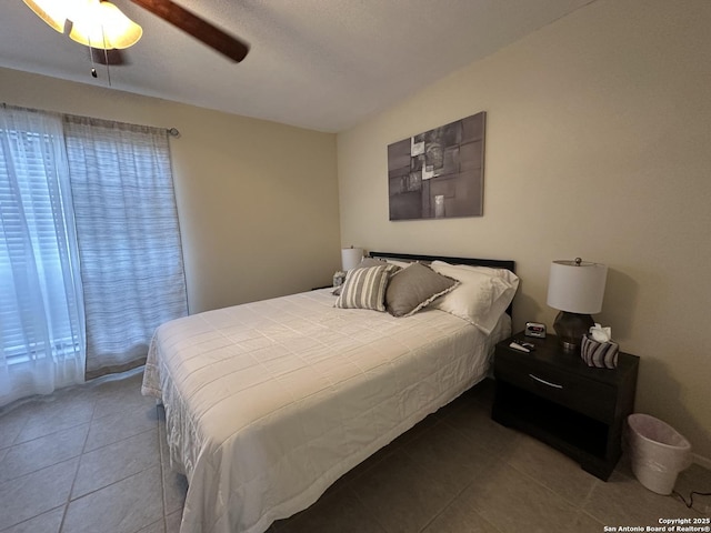 tiled bedroom featuring ceiling fan