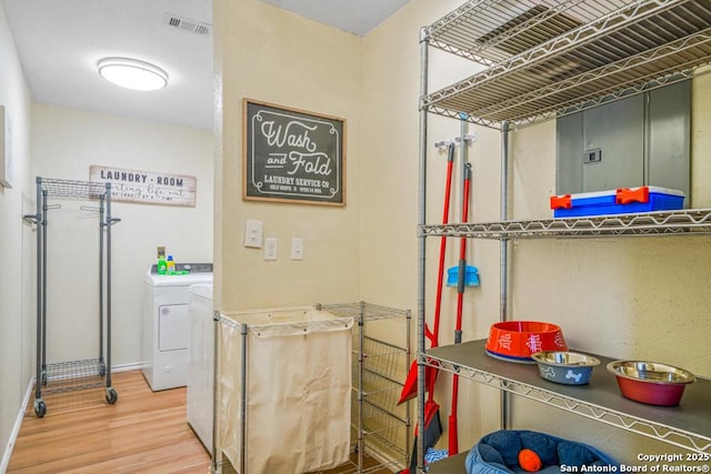 clothes washing area featuring hardwood / wood-style floors