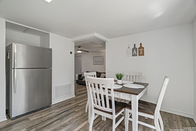 dining space featuring wood-type flooring and ceiling fan