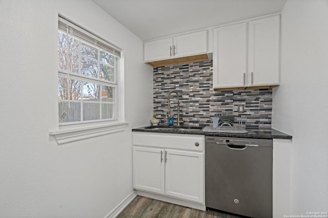 kitchen featuring white cabinets, dishwasher, sink, and backsplash