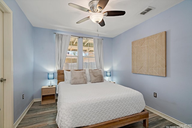 bedroom with dark hardwood / wood-style floors and ceiling fan