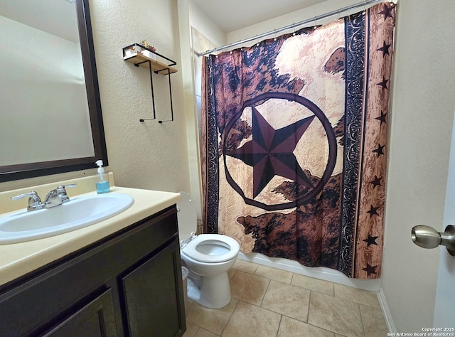 bathroom with vanity, tile patterned flooring, and toilet