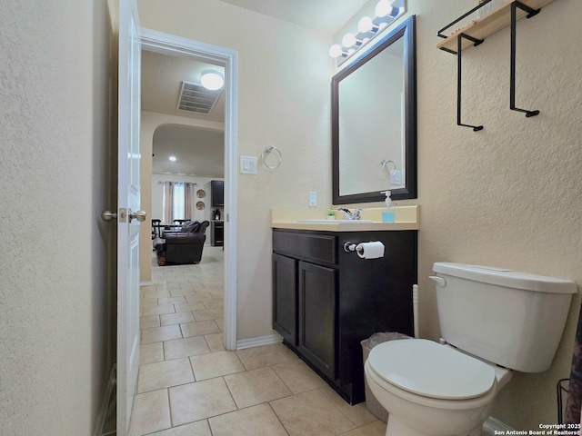 bathroom featuring vanity, toilet, and tile patterned flooring