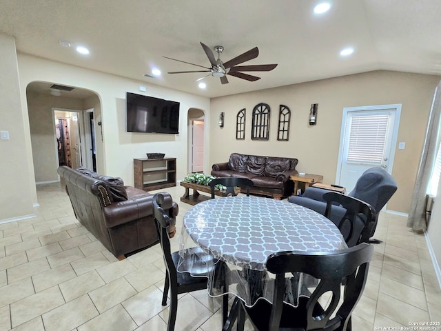 dining space with lofted ceiling, light tile patterned floors, and ceiling fan