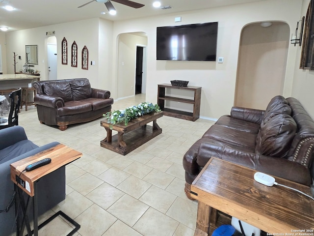 tiled living room with ceiling fan