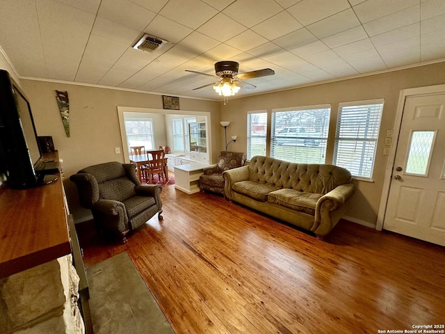 living room featuring crown molding, hardwood / wood-style floors, and ceiling fan