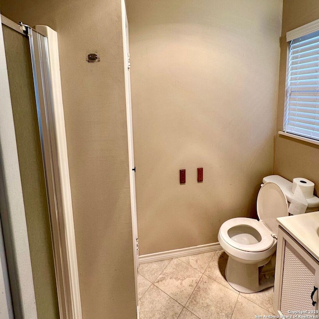 bathroom with tile patterned flooring, vanity, and toilet