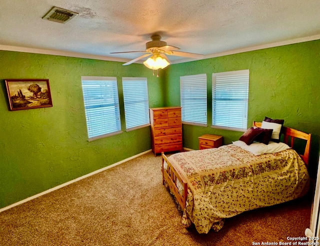 carpeted bedroom with ceiling fan and a textured ceiling