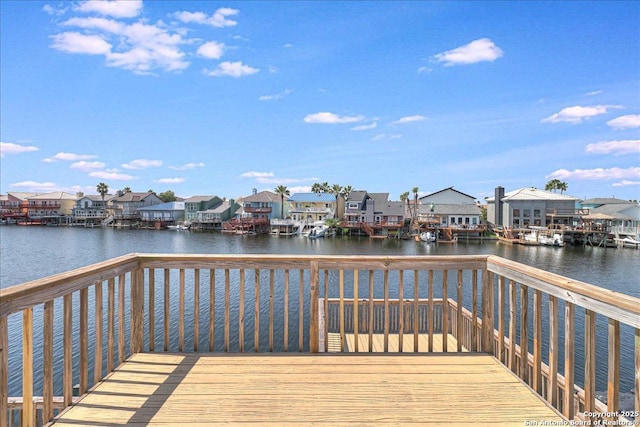 dock area featuring a deck with water view