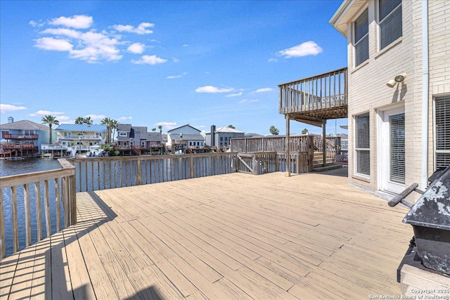 wooden terrace featuring a water view