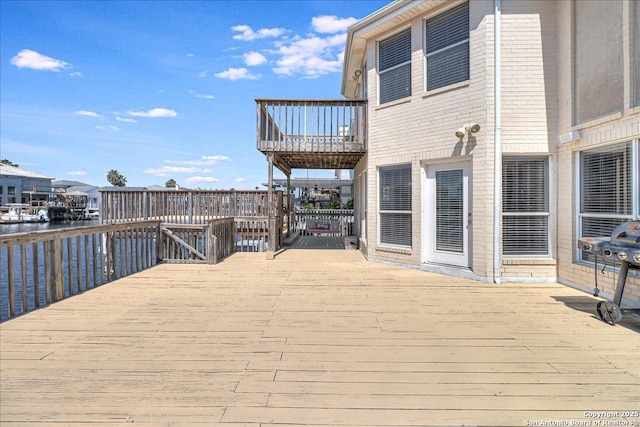 wooden terrace featuring a water view