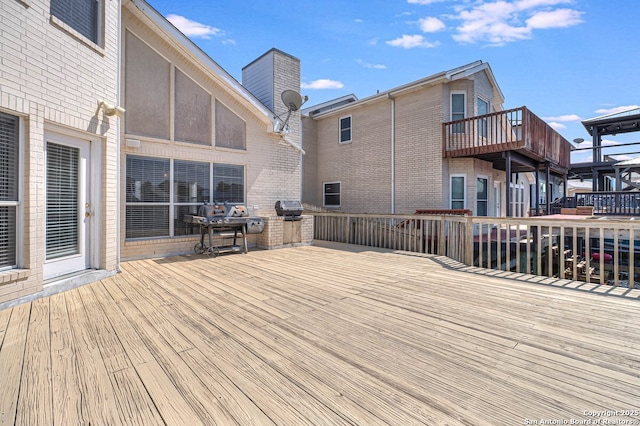 wooden terrace featuring grilling area