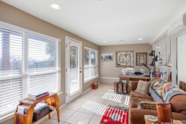 home office with light tile patterned flooring, an AC wall unit, and a wealth of natural light