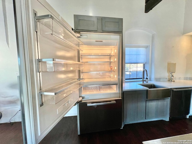 kitchen with sink, fridge, dark hardwood / wood-style floors, dishwasher, and beamed ceiling