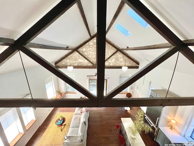 details with hardwood / wood-style flooring, a skylight, and beamed ceiling