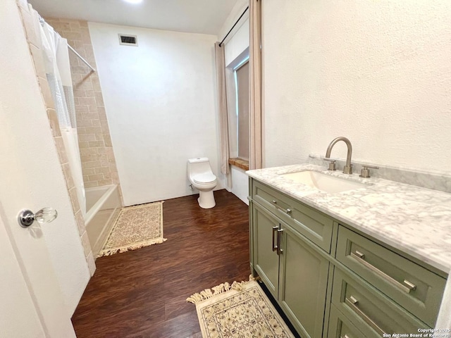 full bathroom featuring vanity, shower / tub combo, wood-type flooring, and toilet