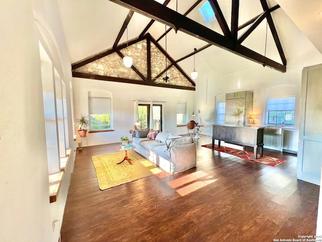 living room with high vaulted ceiling, dark hardwood / wood-style floors, and beamed ceiling