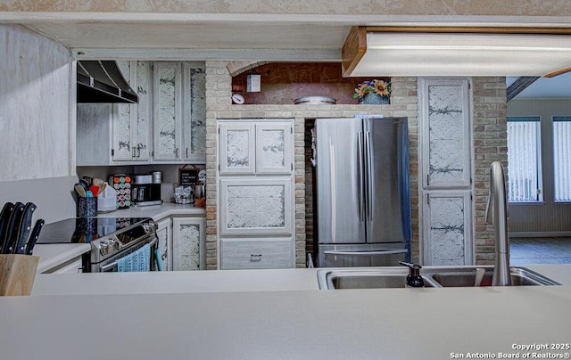 kitchen featuring stainless steel appliances, sink, and exhaust hood