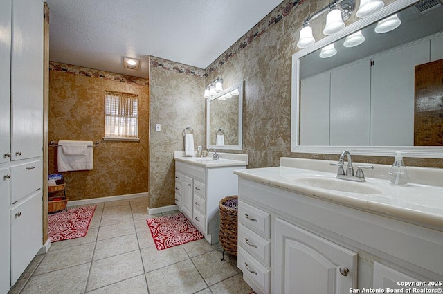 bathroom featuring vanity, tile patterned flooring, and a textured ceiling