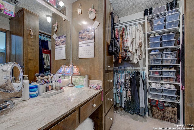 bathroom with vanity and a textured ceiling