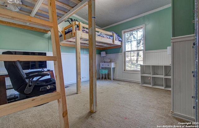 bedroom with crown molding, carpet floors, and a textured ceiling