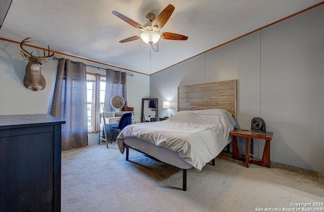 bedroom featuring vaulted ceiling, ornamental molding, ceiling fan, light carpet, and a textured ceiling