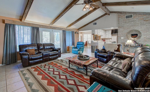 tiled living room featuring vaulted ceiling with beams, ceiling fan, and french doors