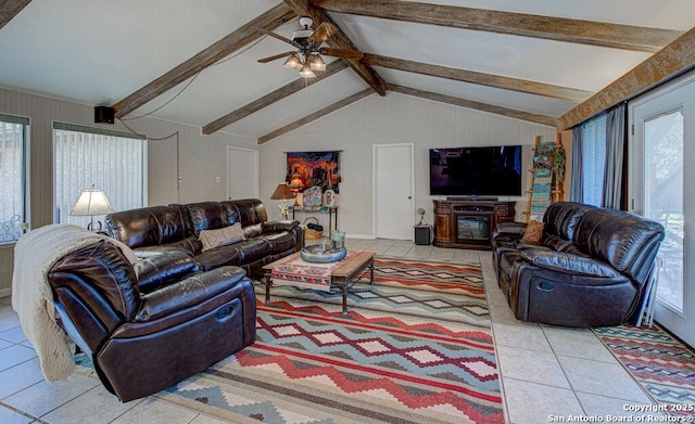 living room with ceiling fan, light tile patterned floors, and vaulted ceiling with beams