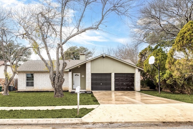 view of front of property with a garage and a front lawn