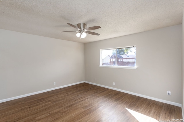 unfurnished room featuring dark hardwood / wood-style flooring, ceiling fan, and a textured ceiling