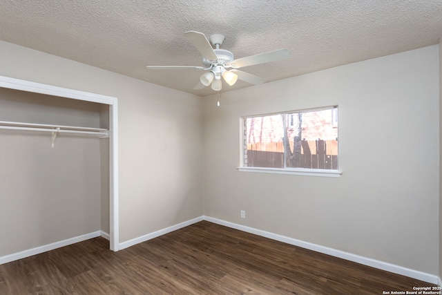 unfurnished bedroom featuring ceiling fan, dark hardwood / wood-style flooring, a closet, and a textured ceiling