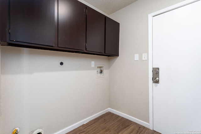 laundry area featuring cabinets, a textured ceiling, electric dryer hookup, hardwood / wood-style flooring, and washer hookup