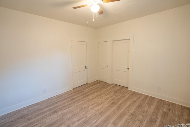 unfurnished room with ceiling fan and light wood-type flooring