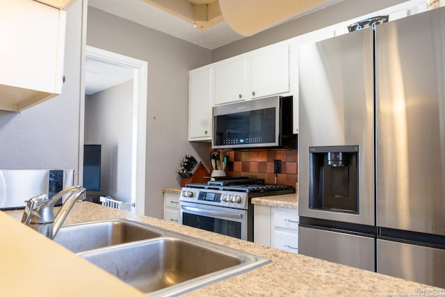 kitchen featuring light countertops, appliances with stainless steel finishes, and white cabinetry