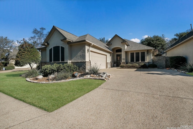 view of front of home featuring a garage and a front yard