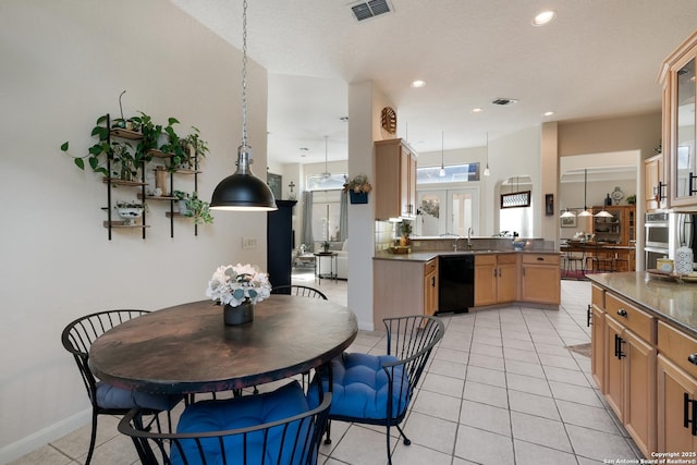 tiled dining room featuring sink