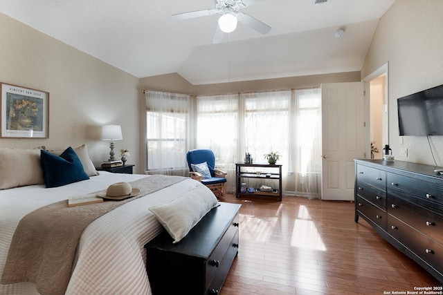 bedroom featuring hardwood / wood-style flooring, vaulted ceiling, and ceiling fan