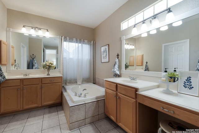 bathroom featuring vanity, tiled bath, and tile patterned flooring