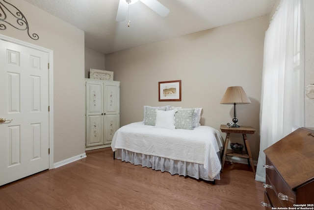 bedroom with ceiling fan and hardwood / wood-style floors